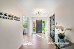 The front door and formal lounge doors, painted in Resene All Black, are the perfect contrast to this neutral hallway in Resene Merino. The ceiling and trims are in Resene Black White. 