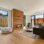 Lounge featuring fireplace with timber surround