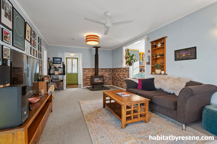 Living room featuring soft blue walls and a bold green front door