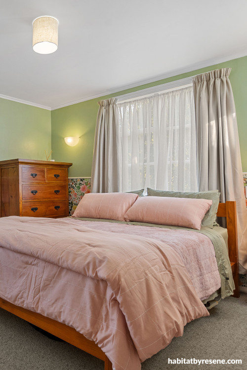 Bedroom featuring soft green walls