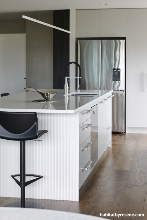 An open plan kitchen with Resene Half Sea Fog and Sandtex in Resene Ash