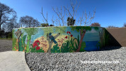 Outdoor mural featuring native birds and nature