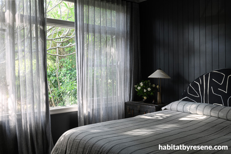 Bedroom featuring walls and ceiling painted in striking black Resene Element