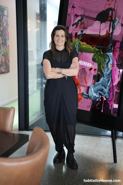 Rachel Rush next to one of her detailed artworks