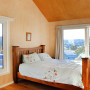 Bedroom featuring timber walls painted in Resene Colorwood Rock Salt