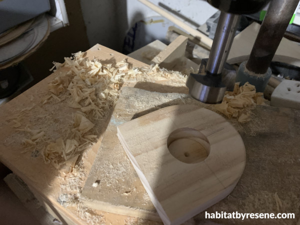 A rounded piece of wood with a round hole in it