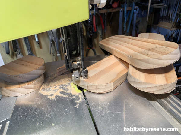 A saw cutting rounded edges into three pieces of wood