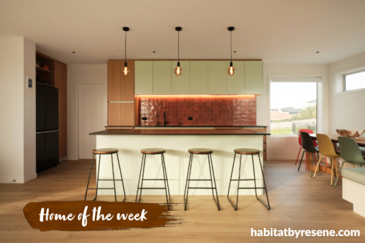 Kitchen featuring coastal-inspired orange and green tones