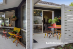 Patio painted in Resene Spanish White and Resene Black with furniture and accessories in bold Resene hues