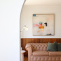 Living area featuring an archway and wood panelling