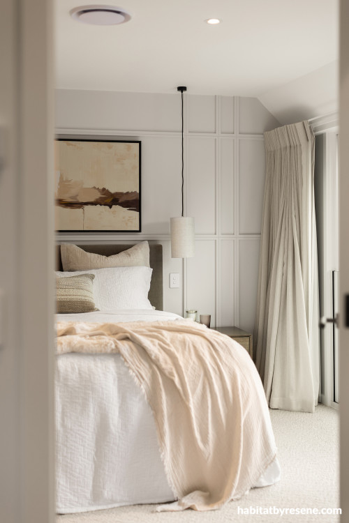 Bedroom with feature wall in Resene White Pointer