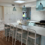 Kitchen painted in soft blue and white tones