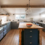 Kitchen featuring cabinetry painted in Resene Rolling Stone and kitchen island in Resene Big Stone