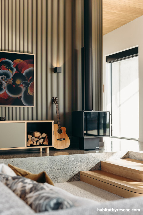 Living room featuring sunken seating area and vertical wall panels