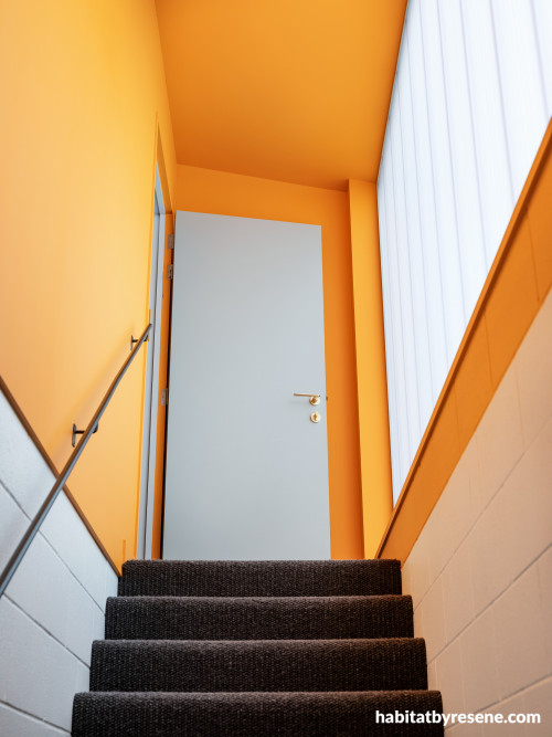 A stairwell painted in Resene Hero