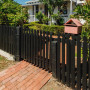 Fence painted in Resene Lumbersider in Resene Black