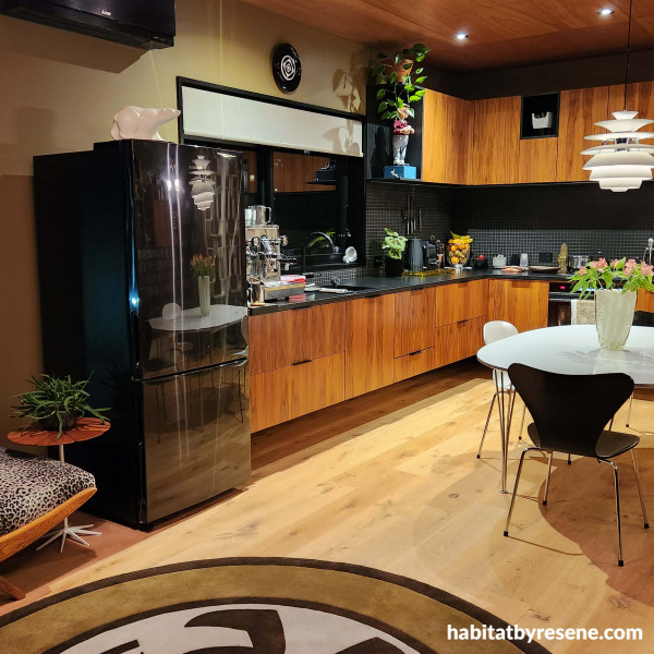 The kitchen is calming with the natural shades of greens and browns. The ply ceiling is finished in Resene Aquaclear satin, walls in Jenny and Paul’s custom made ‘Cohen Green’ - try Resene Highball as an alternative. Trims in Resene Nero.  