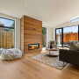 Living room featuring wood panelling and floors, and neutral walls