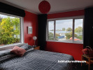 bedroom, red bedroom, master bedroom, red interior, red feature wall, bright bedroom