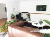 white lounge, white living room, neutral lounge, indoor plants, rimu mantel, renovated lounge