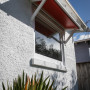 house exterior, White House, red awnings, 1920's villa, black door, Resene 