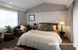 master bedroom, white bedroom, white and grey bedroom, paneled feature wall, neutrals