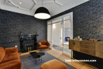 lounge, living room, wallpaper feature wall, grey wallpaper, grey and orange, grey lounge