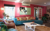 living room, lounge, pink lounge, pink feature wall, blue sofa, pink and blue, resene rouge