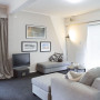 white living room, lounge, white paint, grey couch, dark carpet